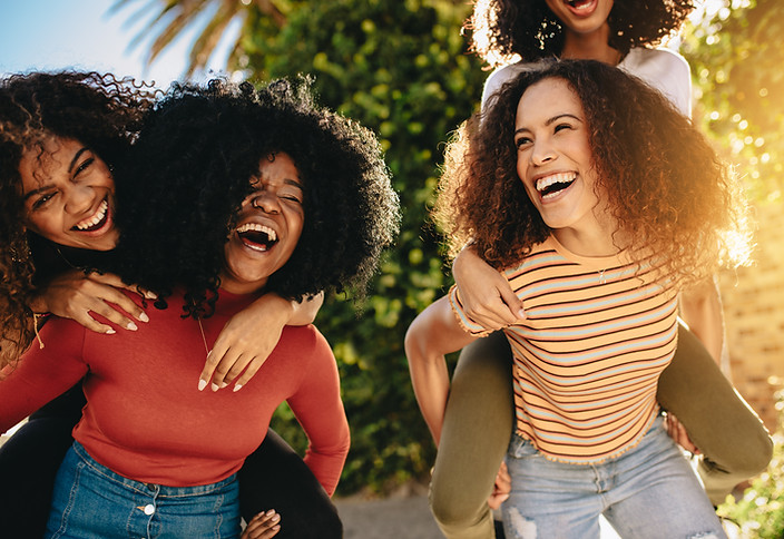 Cheerful female friends walking outdoors